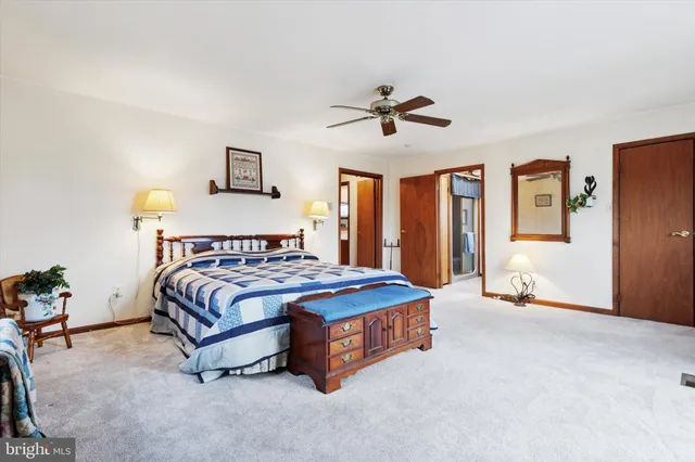 a bathroom with a granite countertop sink a toilet and a mirror