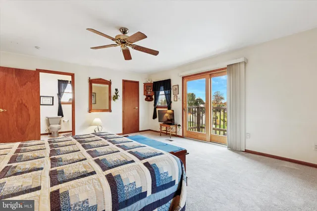 a bedroom with a bed and glass walk in closet