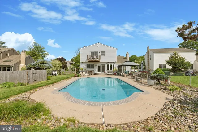 a view of a house with pool and a yard