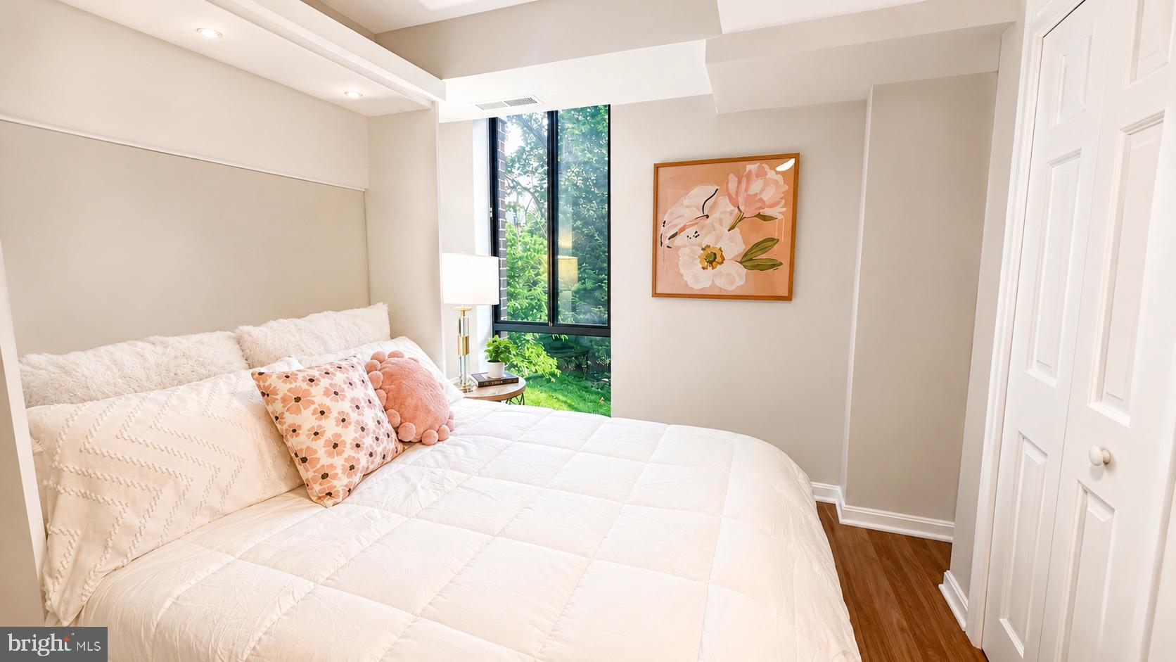 1401 North Rhodes Street, Unit 102 Arlington, VA 22209 - Photo 15 of 21 a bedroom with a large bed and a window