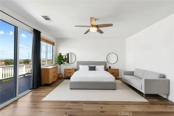 a spacious bathroom with a granite countertop sink a mirror a bathtub and next to a window