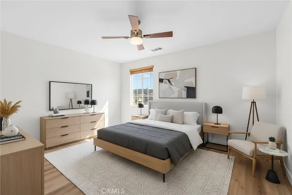 a view of a big room with wooden floor and windows
