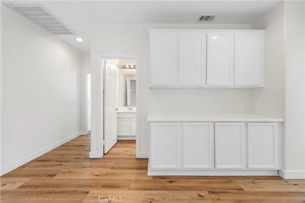 a spacious bathroom with a granite countertop sink a mirror and a bathtub