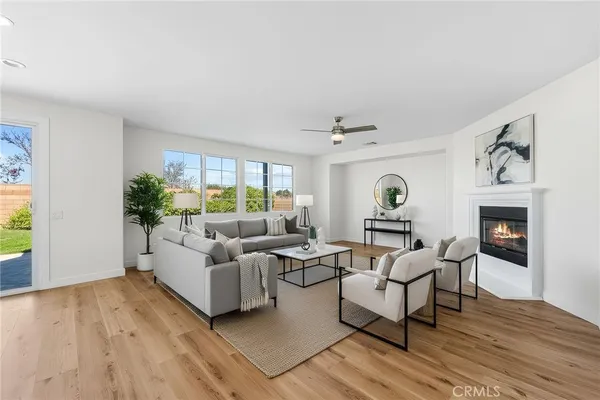 a kitchen with stainless steel appliances granite countertop a table chairs sink refrigerator and cabinets