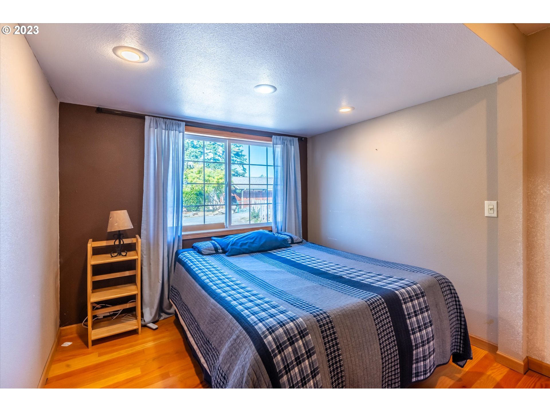 945 2nd Street Southeast Bandon, OR 97411 - Photo 14 of 29 a bedroom with a bed and a window