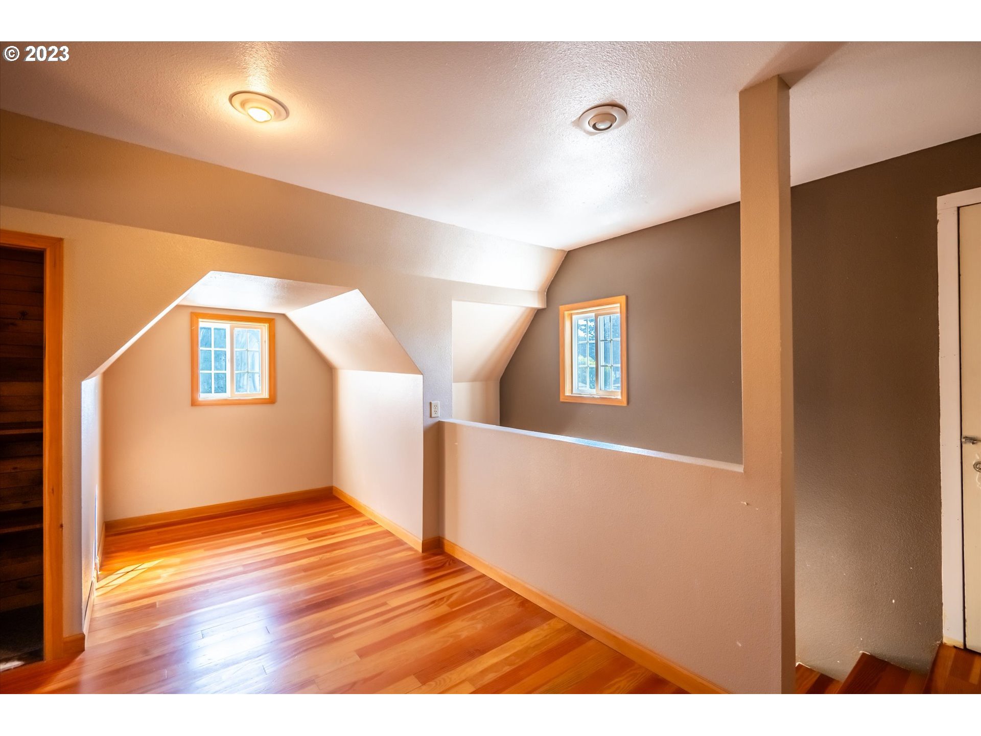 945 2nd Street Southeast Bandon, OR 97411 - Photo 17 of 29 a view of an empty room with wooden floor