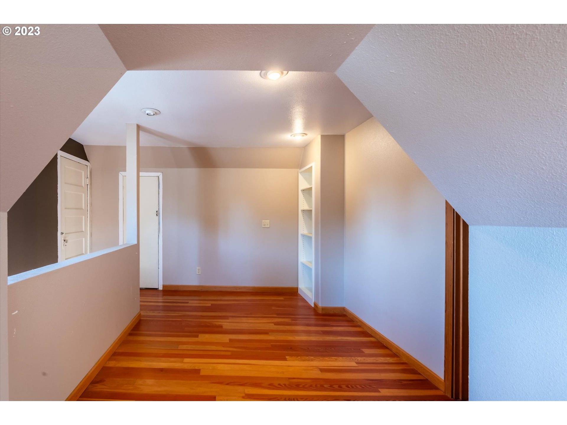 945 2nd Street Southeast Bandon, OR 97411 - Photo 19 of 29 a view of an empty room with wooden floor