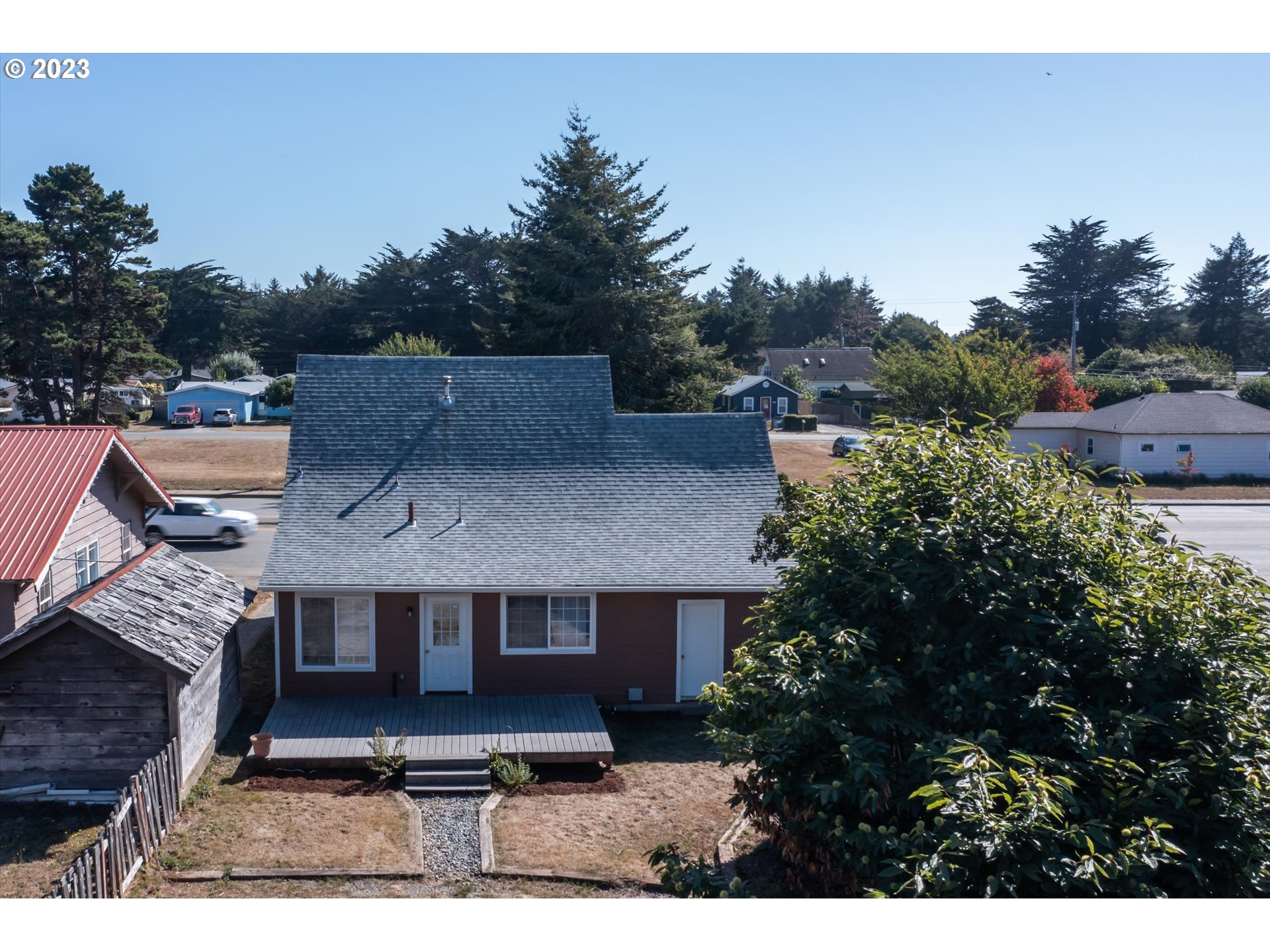 945 2nd Street Southeast Bandon, OR 97411 - Photo 28 of 29 a aerial view of a house with a yard and sitting area