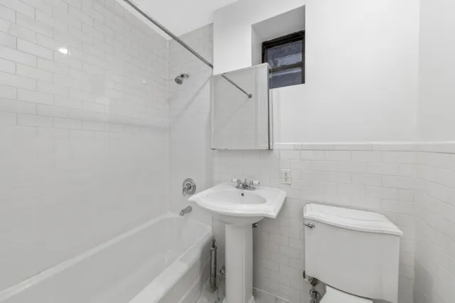 a bathroom with a sink a toilet and bathtub