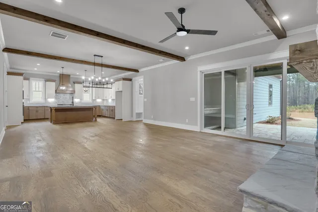 a kitchen with kitchen island granite countertop a sink cabinets and stainless steel appliances