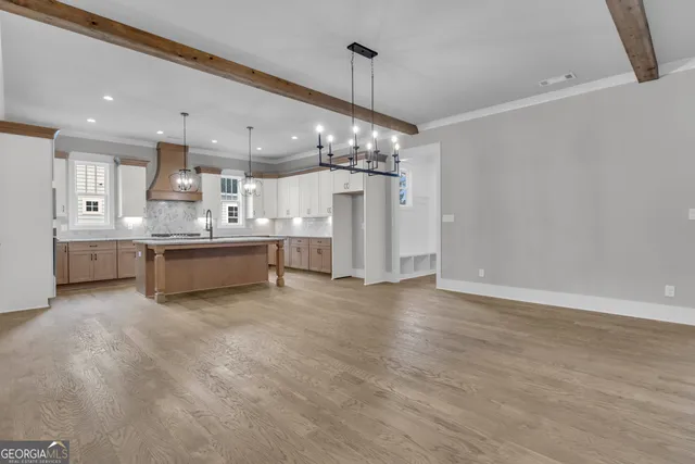 a large kitchen with stainless steel appliances granite countertop a sink and cabinets