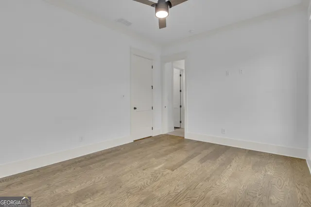 a en suite bathroom with a granite countertop sink mirror and double
