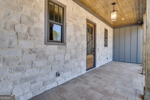 a view of a hallway with wooden floor and closet