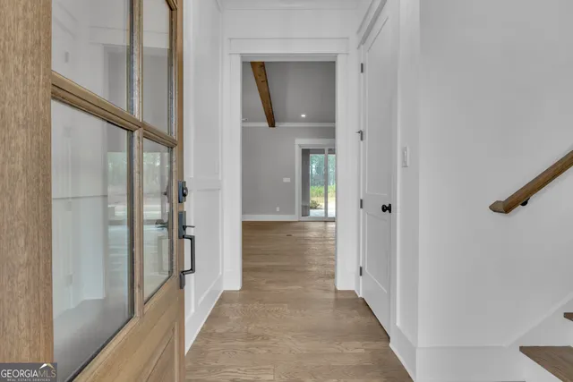 an empty room with fireplace cabinet and windows