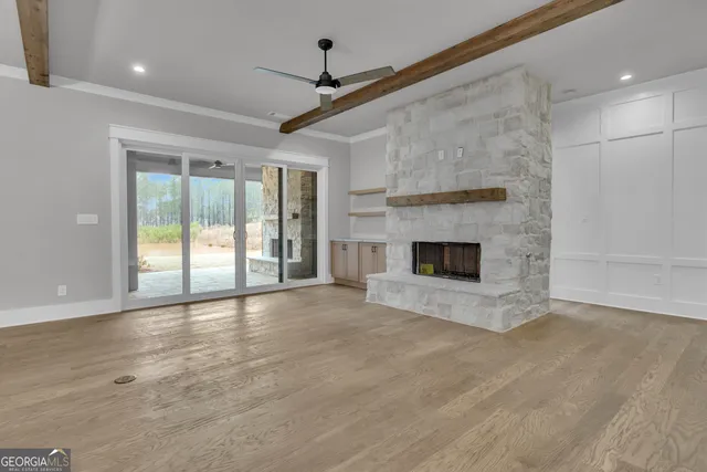a view of empty room with a fireplace and cabinet