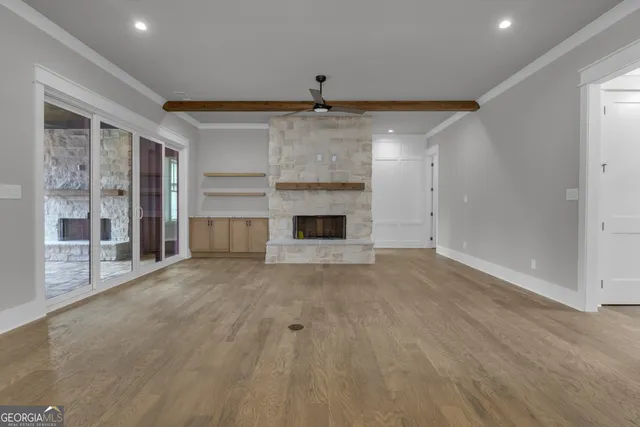 a large room with chandelier and kitchen view