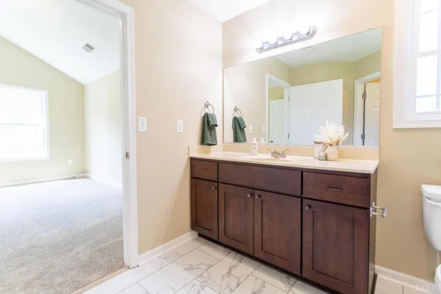a bathroom with a sink vanity and mirror