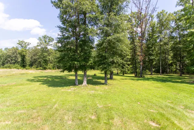 a view of a house with a yard and sitting area