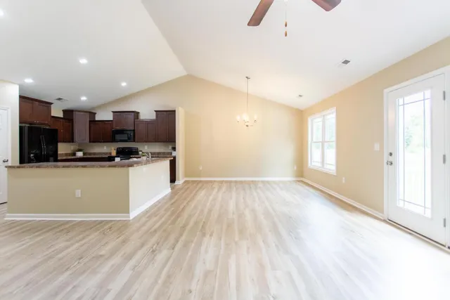 a view of kitchen with wooden floor and electronic appliances