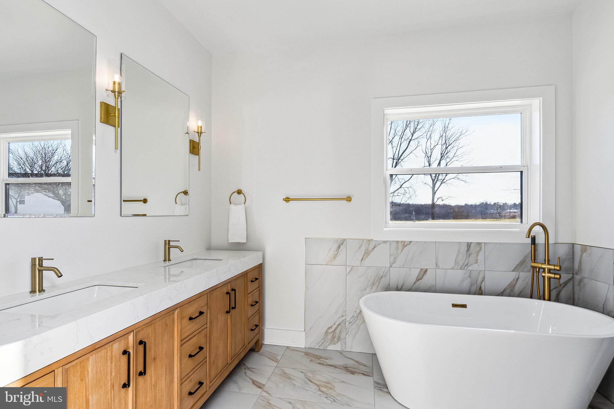 3651 Hanover Pike Manchester, MD 21102 - Photo 12 of 30 a bathroom with a bathtub a sink and a window