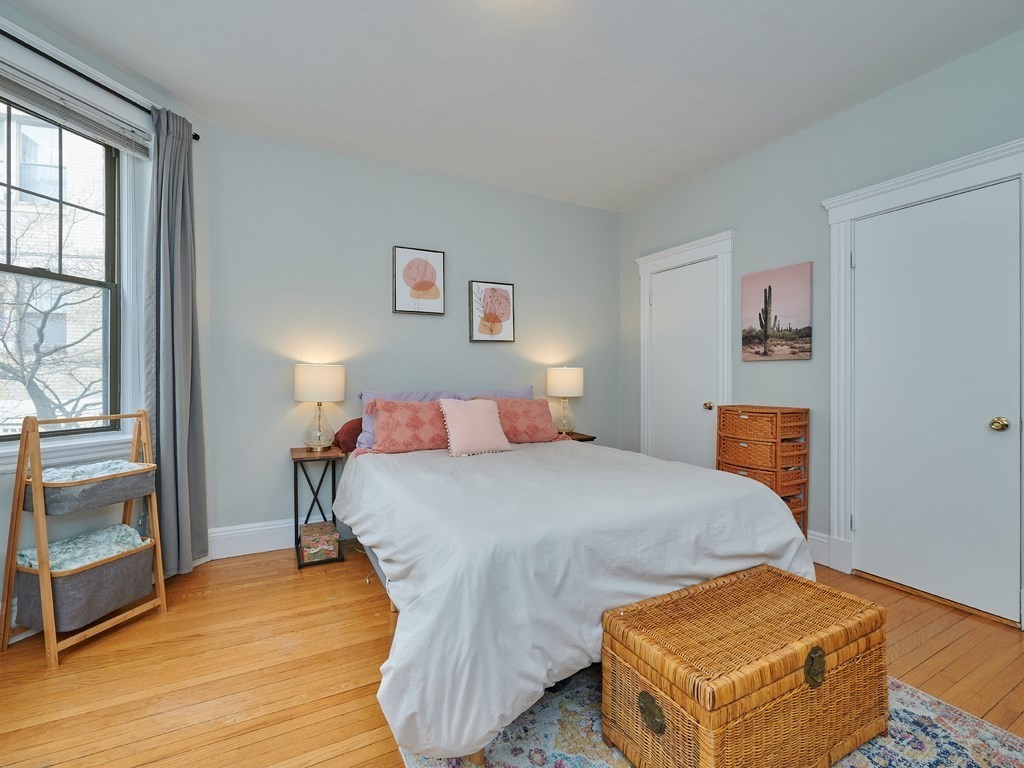 2 Sutherland Road, Unit 2 Boston, MA 02135 - Photo 6 of 11 a bedroom with a bed and wooden floor