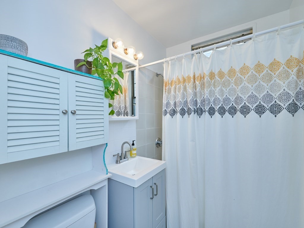 2 Sutherland Road, Unit 2 Boston, MA 02135 - Photo 8 of 11 a bathroom with a sink and a mirror