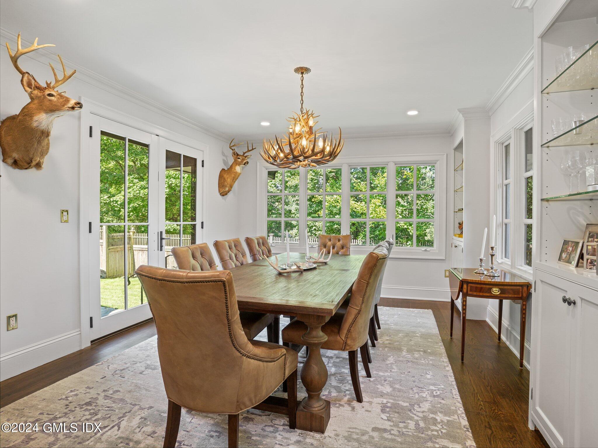 80 Porchuck Road Greenwich, CT 06831 - Photo 11 of 29 a dining room with furniture a chandelier and wooden floor