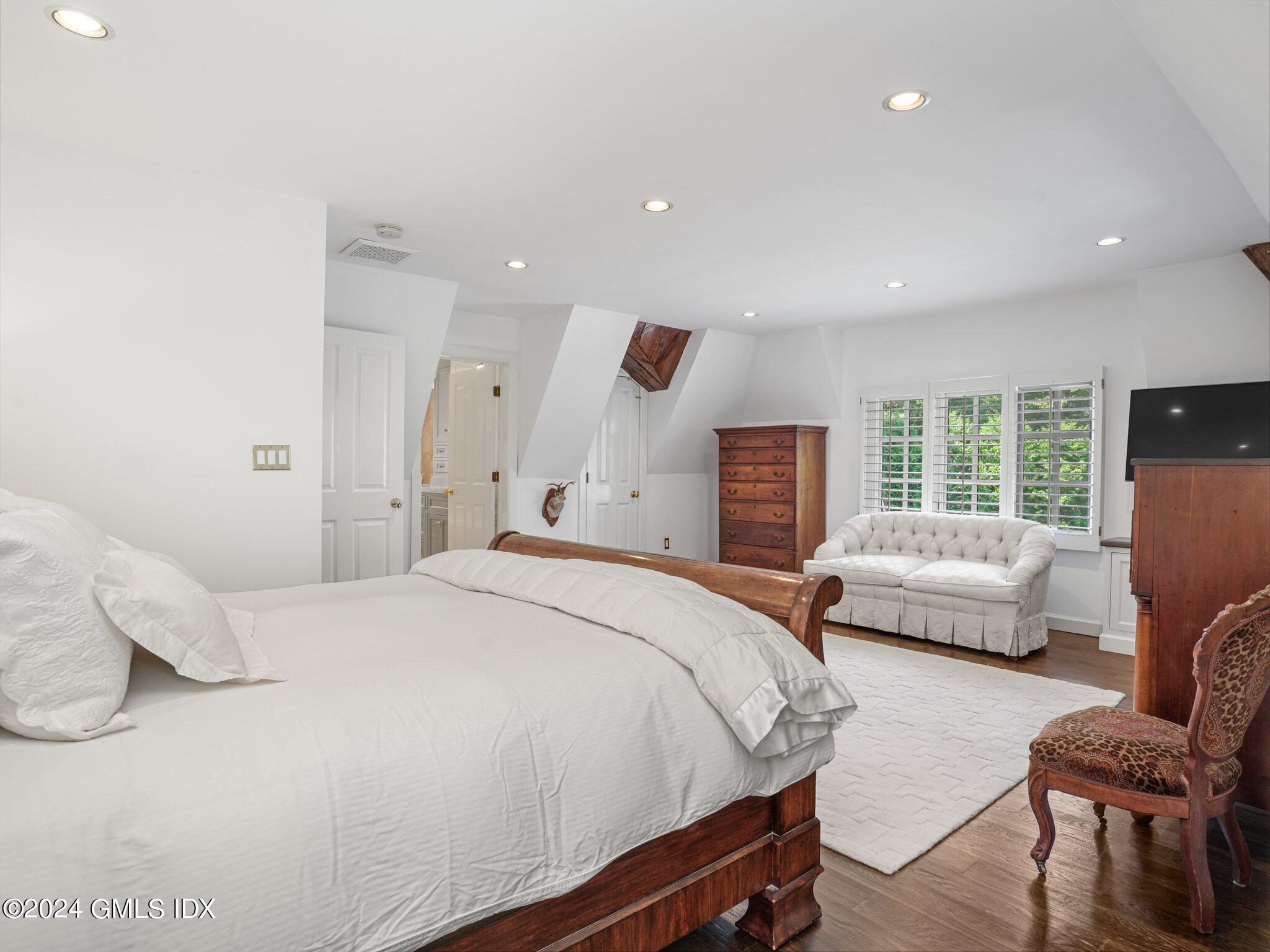 80 Porchuck Road Greenwich, CT 06831 - Photo 15 of 29 a spacious bedroom with a bed and a couch