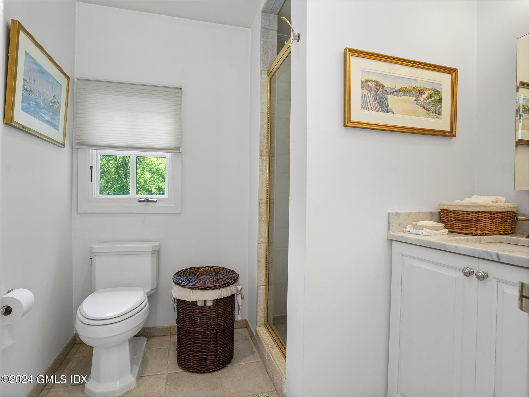 80 Porchuck Road Greenwich, CT 06831 - Photo 20 of 29 a bathroom with a toilet a sink and a window