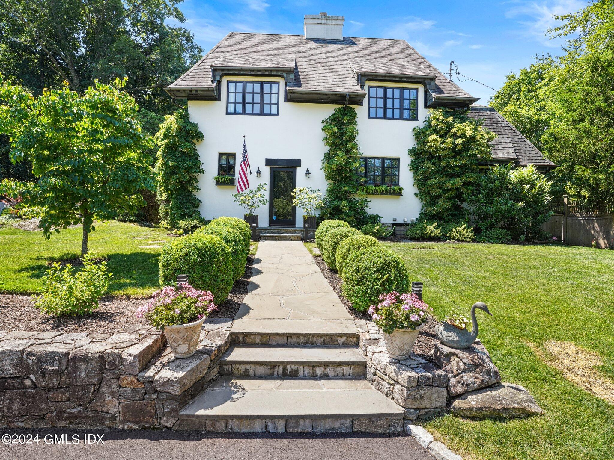 80 Porchuck Road Greenwich, CT 06831 - Photo 2 of 29 a front view of a house with a yard