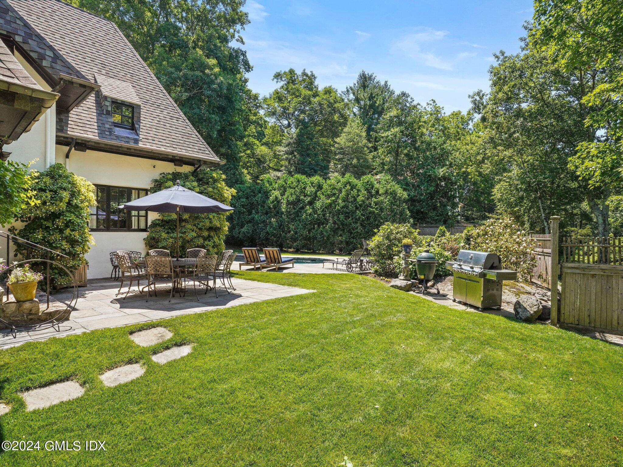 80 Porchuck Road Greenwich, CT 06831 - Photo 24 of 29 a view of a house with swimming pool and sitting area