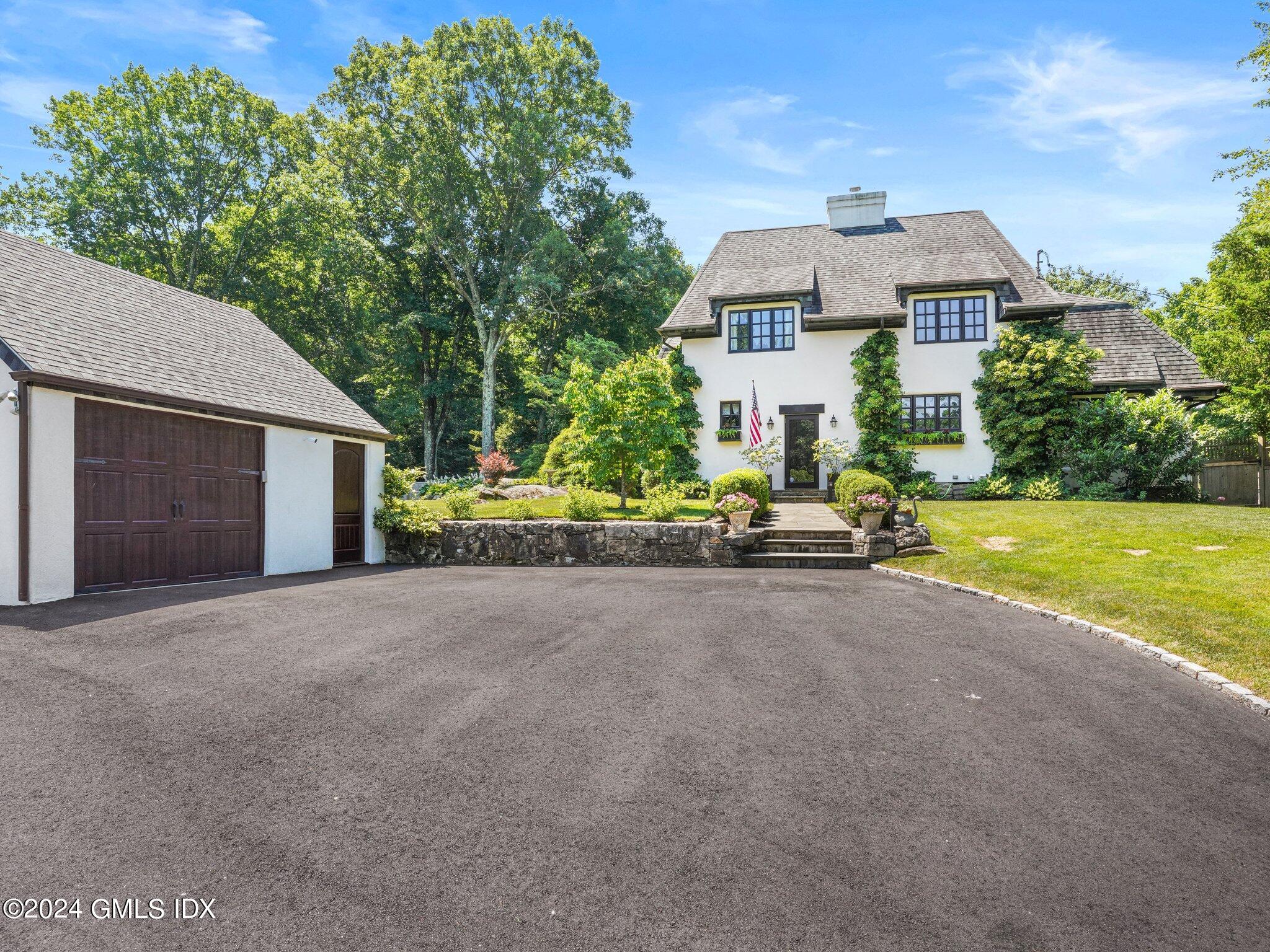 80 Porchuck Road Greenwich, CT 06831 - Photo 29 of 29 a front view of a house with a yard and garage