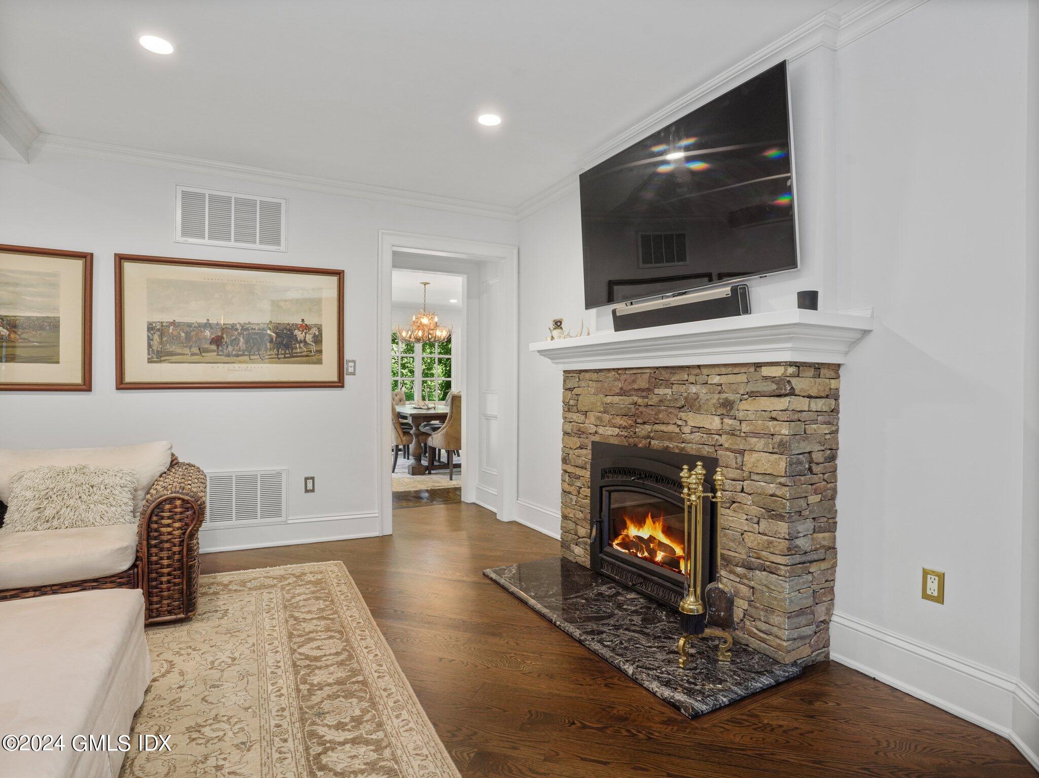 80 Porchuck Road Greenwich, CT 06831 - Photo 6 of 29 a living room with furniture a flat screen tv and a fireplace