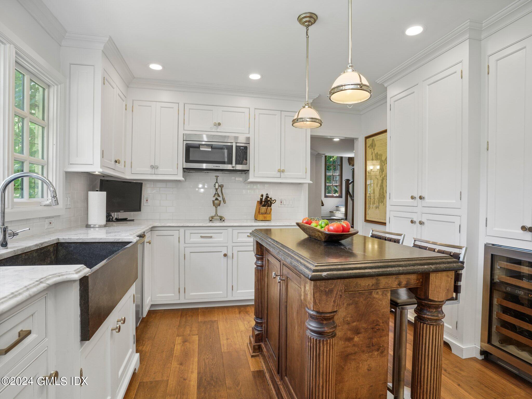 80 Porchuck Road Greenwich, CT 06831 - Photo 10 of 29 a kitchen with kitchen island granite countertop a sink cabinets and window