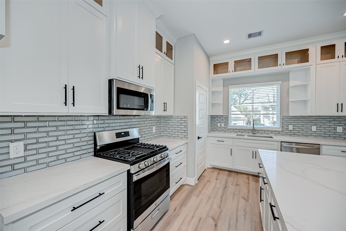 1718 Hardy Street Houston, TX 77026 - Photo 11 of 23 a kitchen with granite countertop stainless steel appliances a stove microwave and sink
