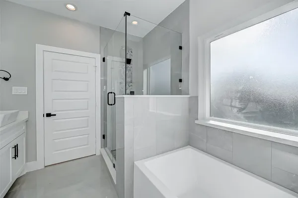 a bathroom with a bathtub and a shower