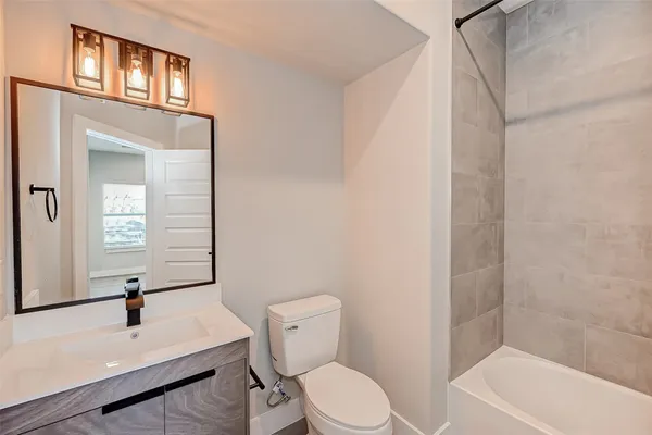a white toilet sitting next to a bathroom sink