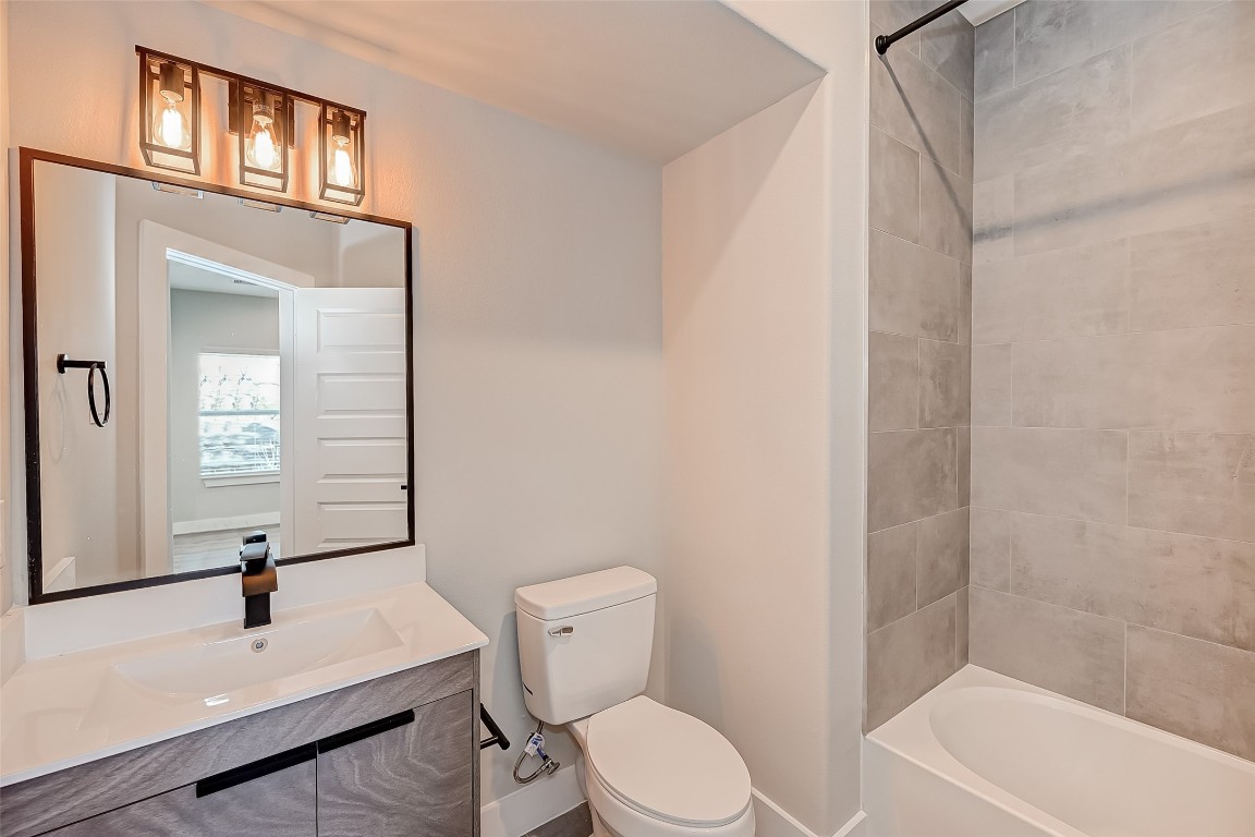 1718 Hardy Street Houston, TX 77026 - Photo 22 of 23 a white toilet sitting next to a bathroom sink