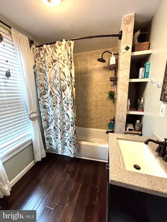 a bathroom with a bathtub and shower