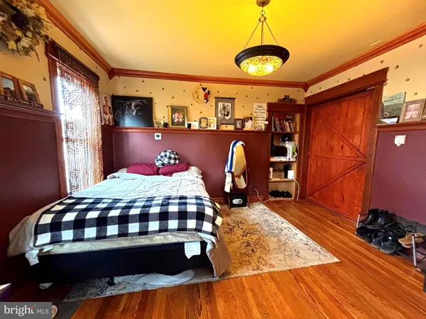 a bedroom with a bed mirror and a window
