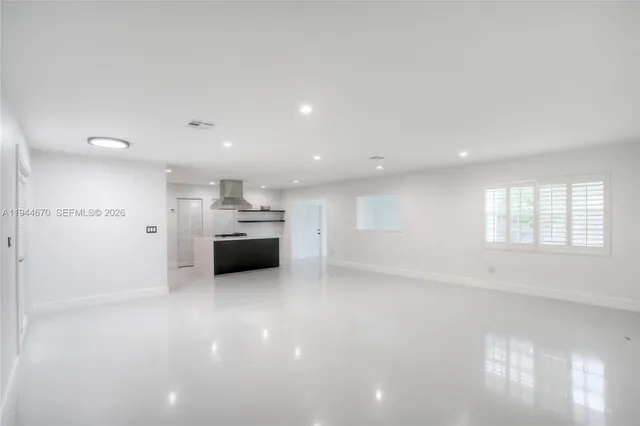 a view of a kitchen with a sink and a window