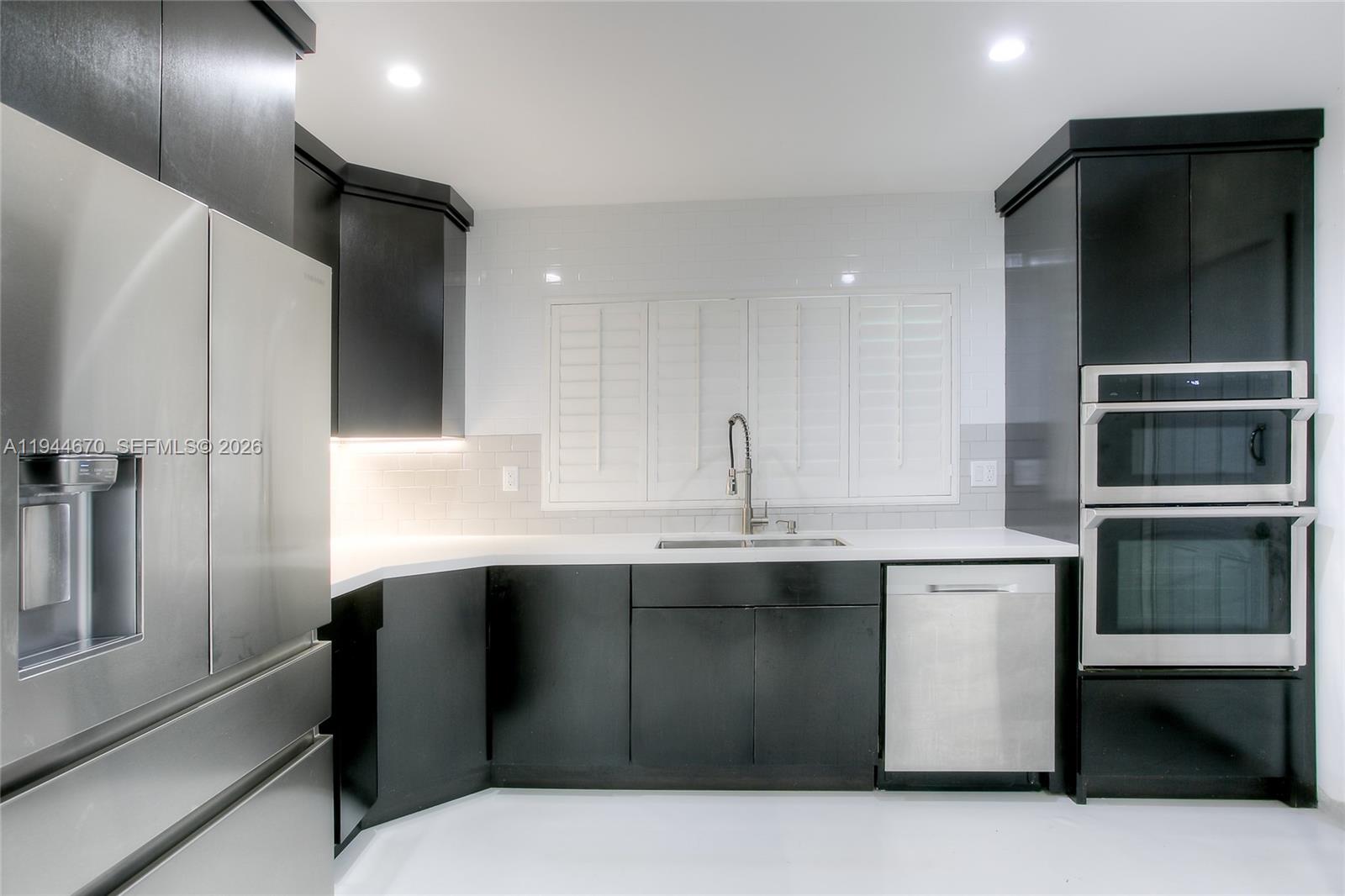 9825 Southwest 196th Street Cutler Bay, FL 33157 - Photo 5 of 14 a kitchen with stainless steel appliances a sink and cabinets