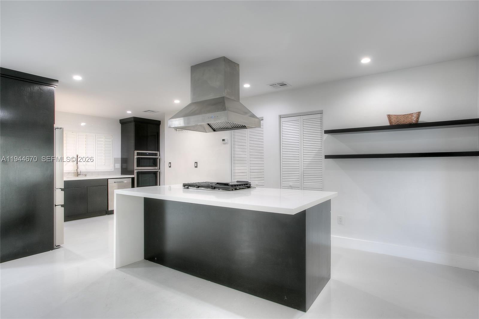 9825 Southwest 196th Street Cutler Bay, FL 33157 - Photo 6 of 14 a kitchen with stainless steel appliances a sink a stove a refrigerator and a oven