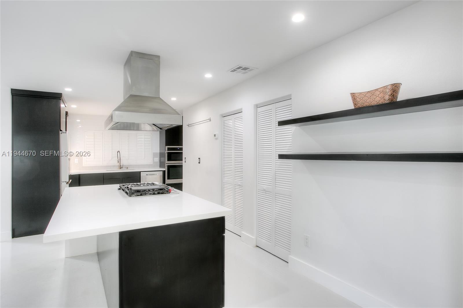 9825 Southwest 196th Street Cutler Bay, FL 33157 - Photo 7 of 14 a kitchen with stainless steel appliances a sink stove and refrigerator