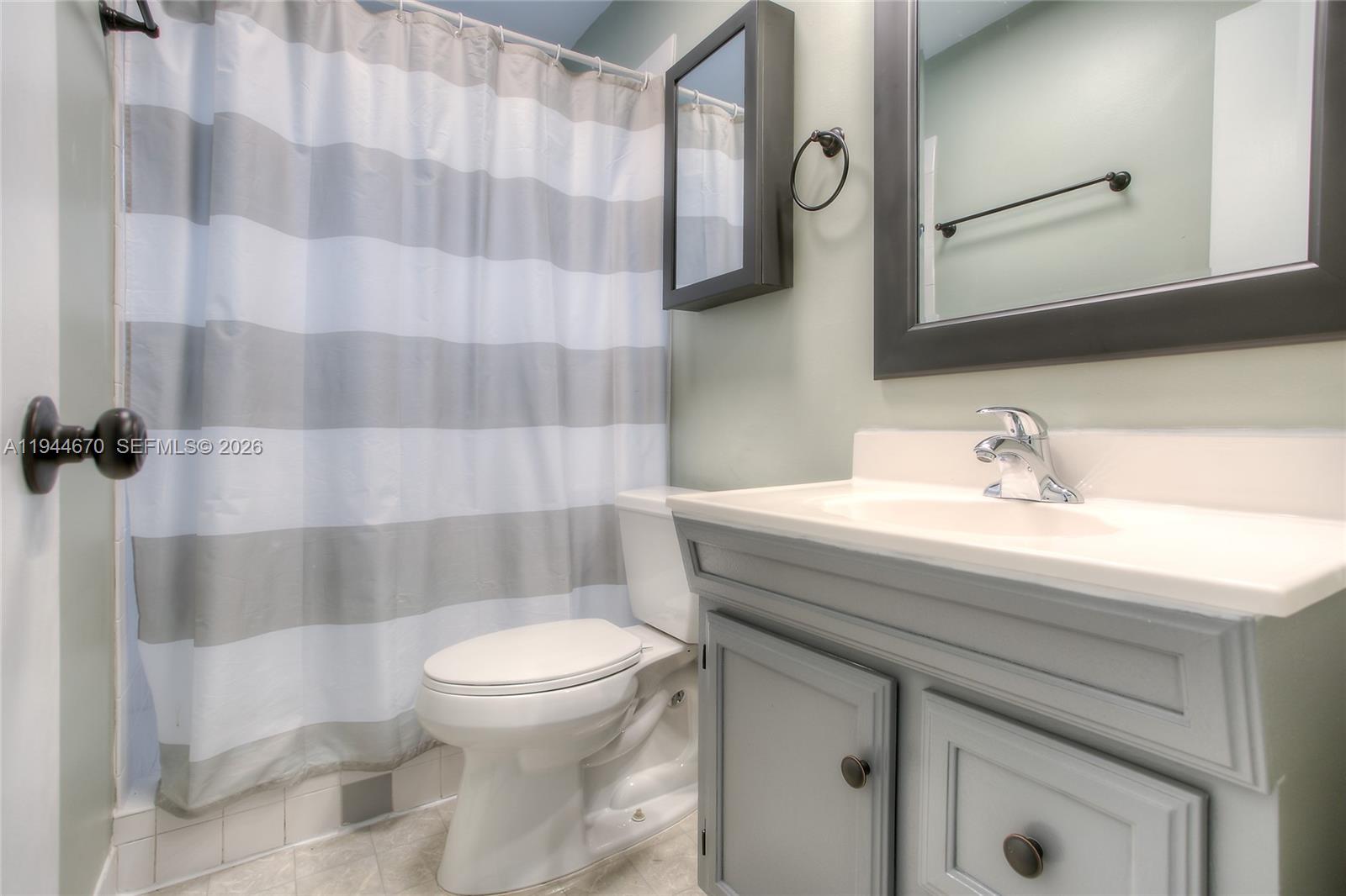 9825 Southwest 196th Street Cutler Bay, FL 33157 - Photo 9 of 14 a bathroom with a sink toilet and shower