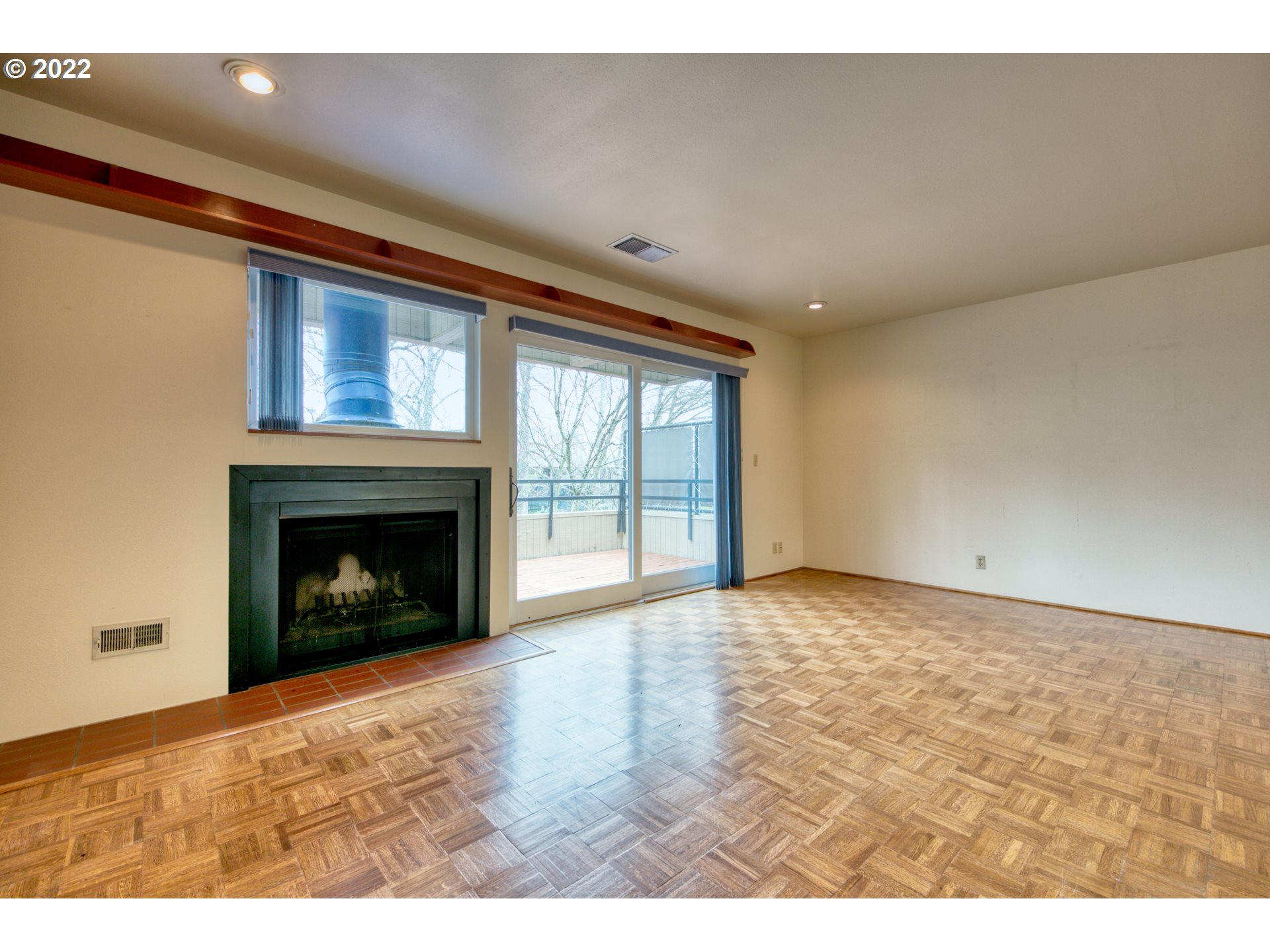 974 Lincoln Street Eugene, OR 97401 - Photo 13 of 32 a view of an empty room with a fireplace and a window