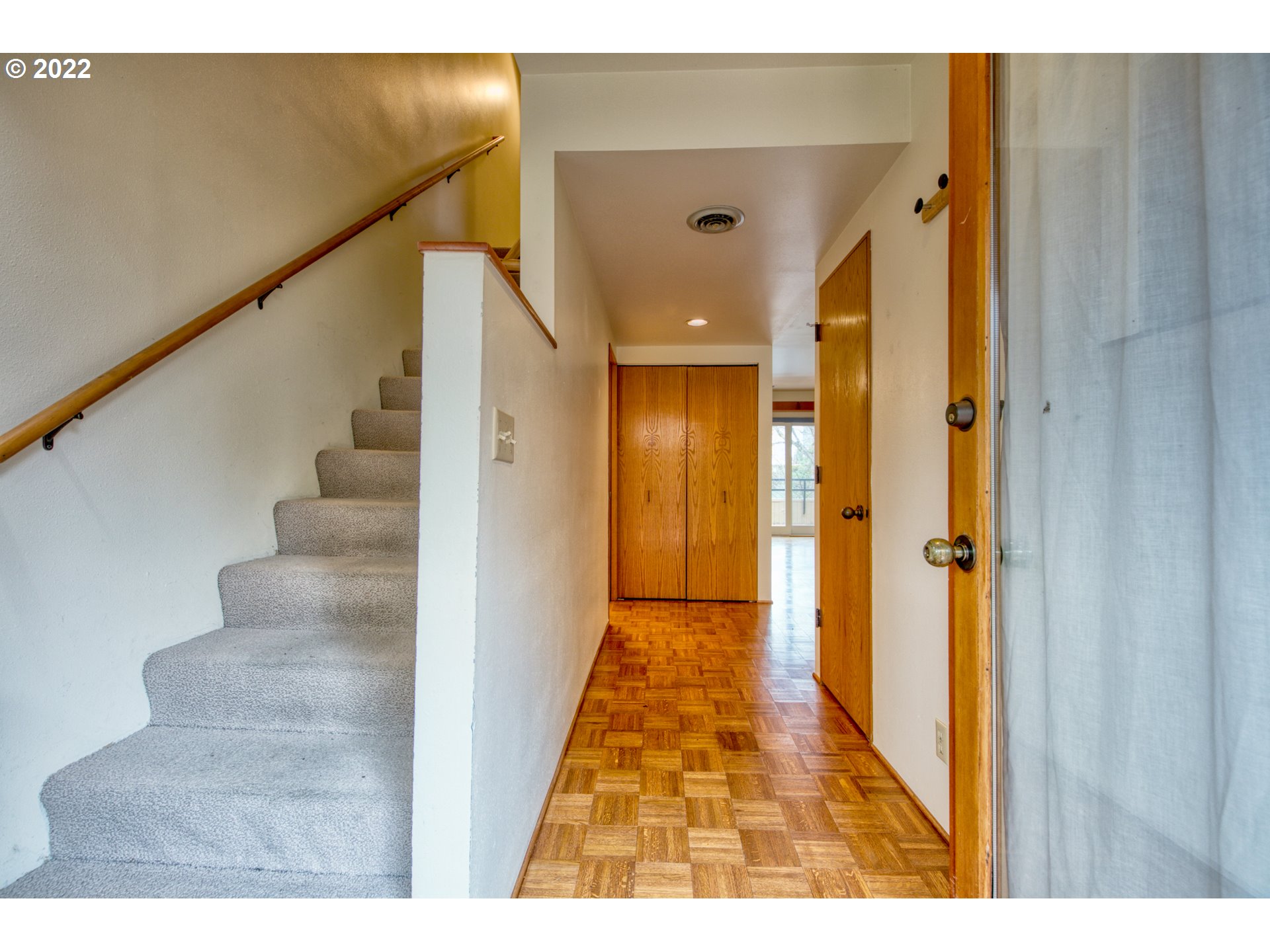 974 Lincoln Street Eugene, OR 97401 - Photo 5 of 32 a view of a hallway with wooden floor and staircase