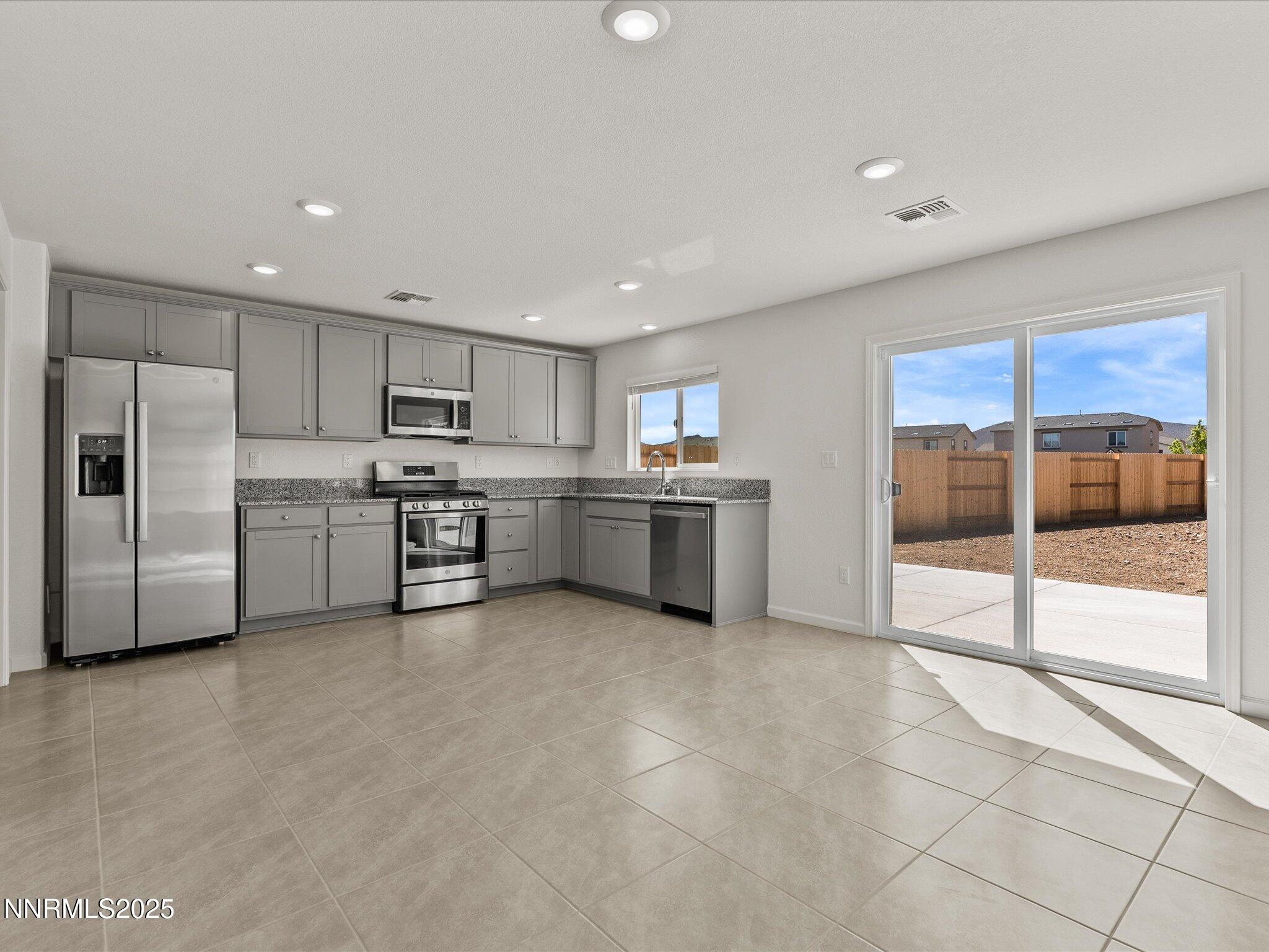 8838 Finnsech Drive Reno, NV 89506 - Photo 11 of 44 a kitchen with stainless steel appliances a refrigerator sink and cabinets
