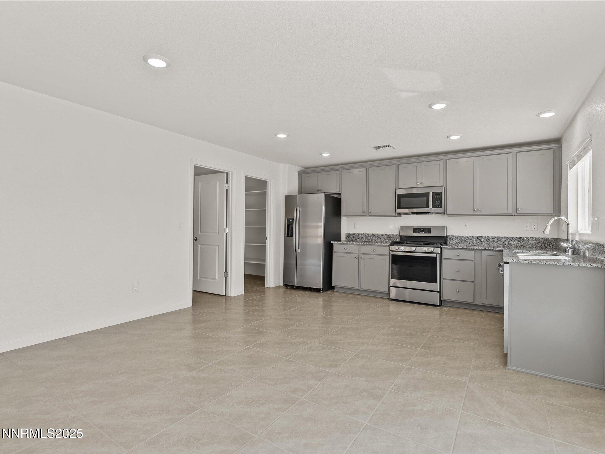 8838 Finnsech Drive Reno, NV 89506 - Photo 12 of 44 a view of kitchen with refrigerator sink microwave and stove
