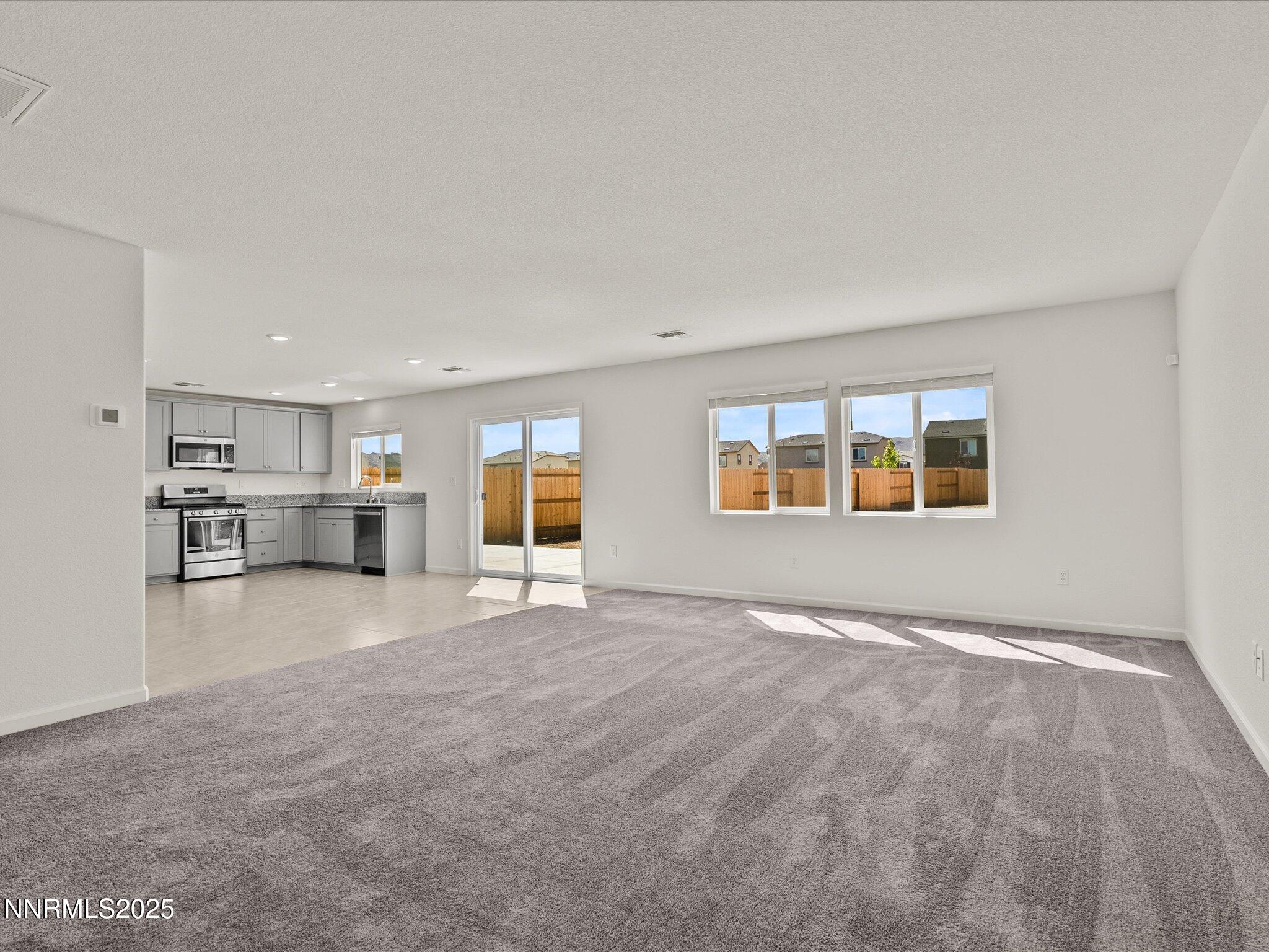 8838 Finnsech Drive Reno, NV 89506 - Photo 9 of 44 a view of empty room with kitchen and window